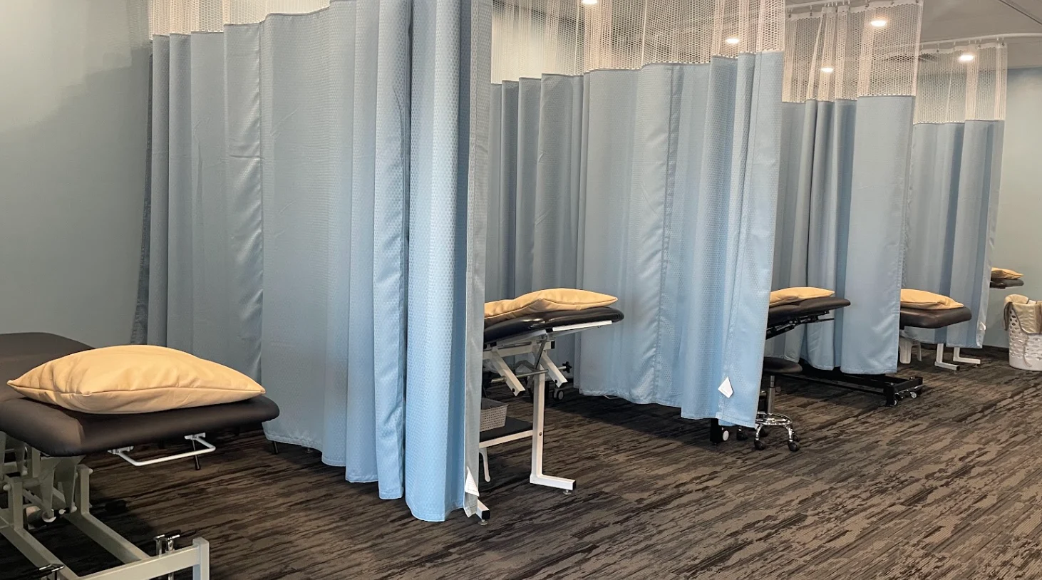 Physiotherapy treatment beds with privacy curtains