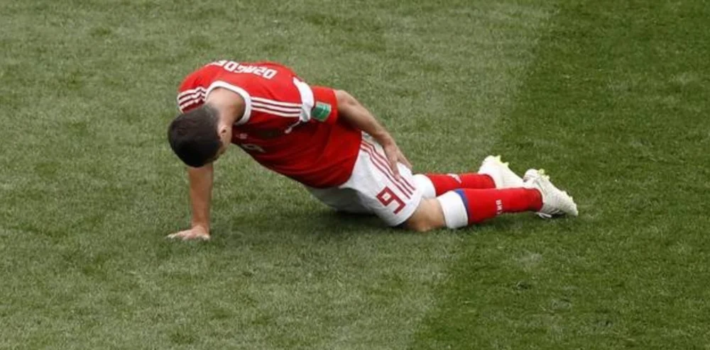 Soccer player with hamstring strain on the pitch